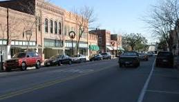 Downtown Conway street with historic storefronts and parked cars